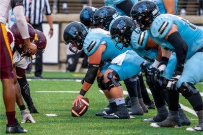 Grand Valley offensive linemen line up along the line of scrimmage against Central State defense.